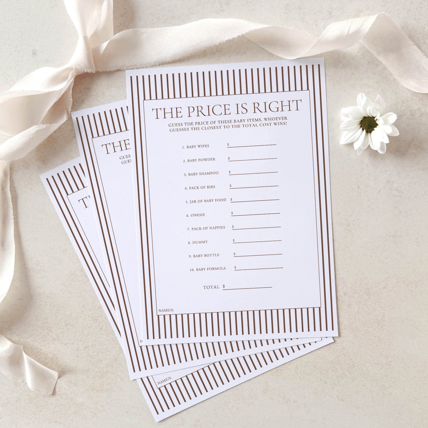 Two 'The Price is Right' baby shower game sheets on a light background with ribbons and a flower.