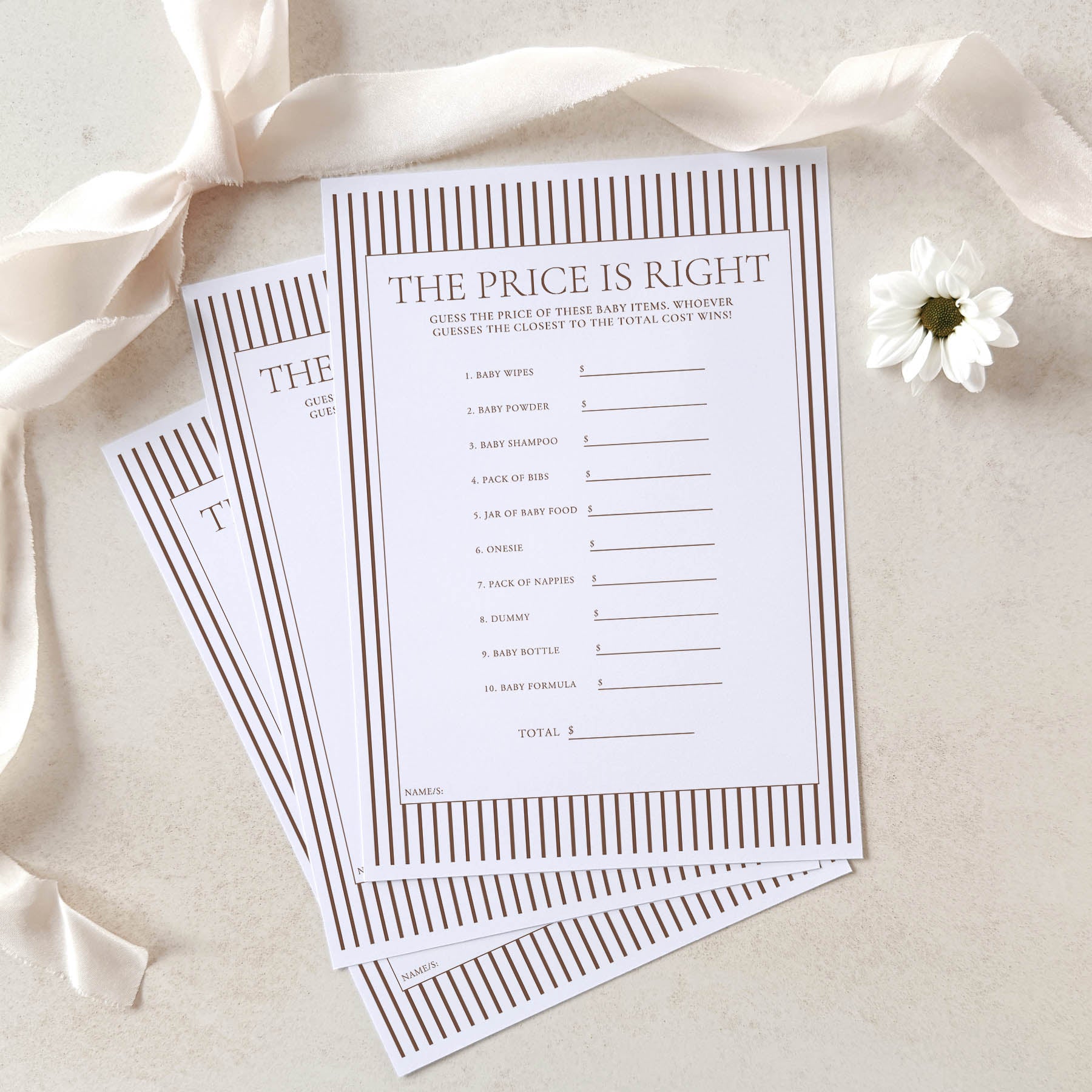 Two 'The Price is Right' baby shower game sheets on a light background with ribbons and a flower.