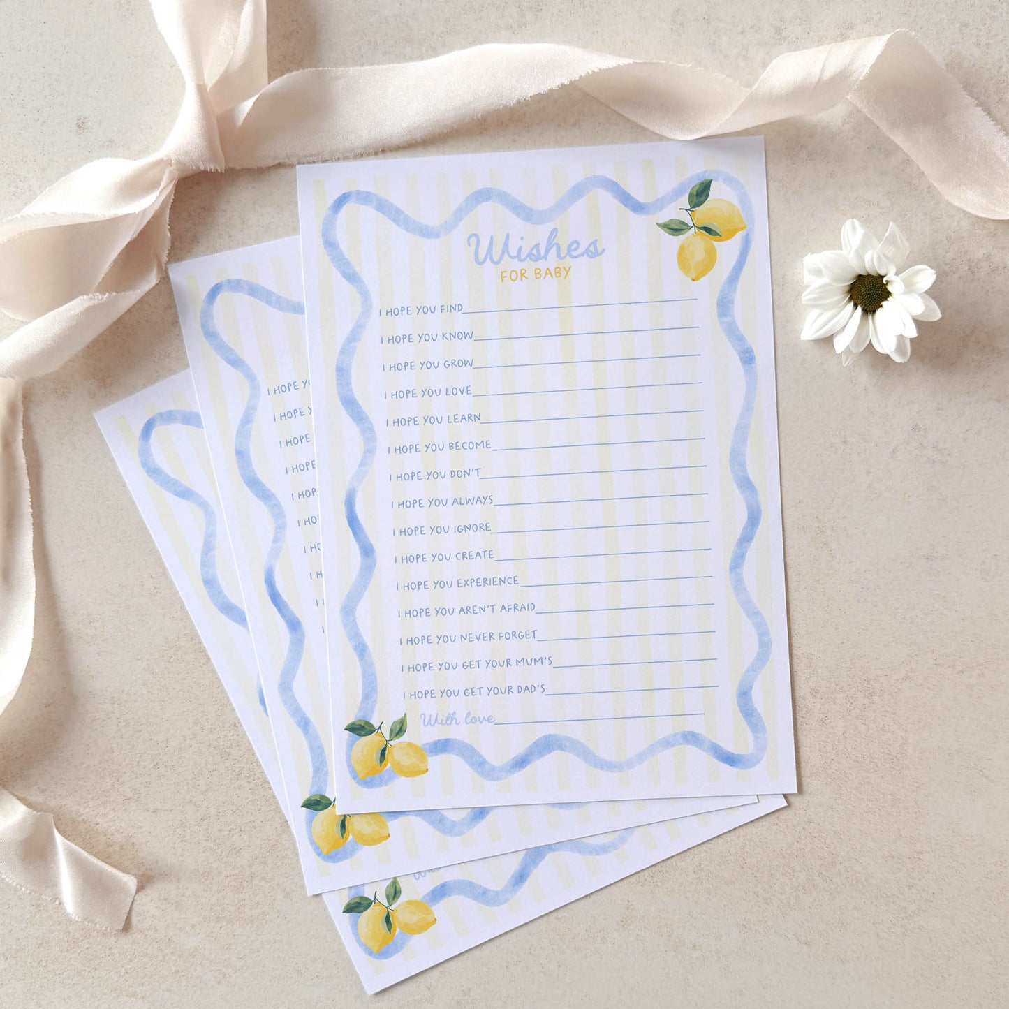 Two sheets of paper with decorative borders and lemon illustrations on a beige background with ribbons and flowers.