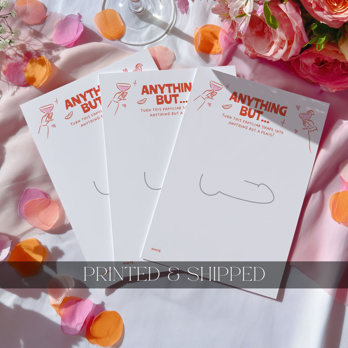 Four hens party game cards with pink wavy borders and icons, arranged on a white fabric background with pink and orange flower petals and roses.