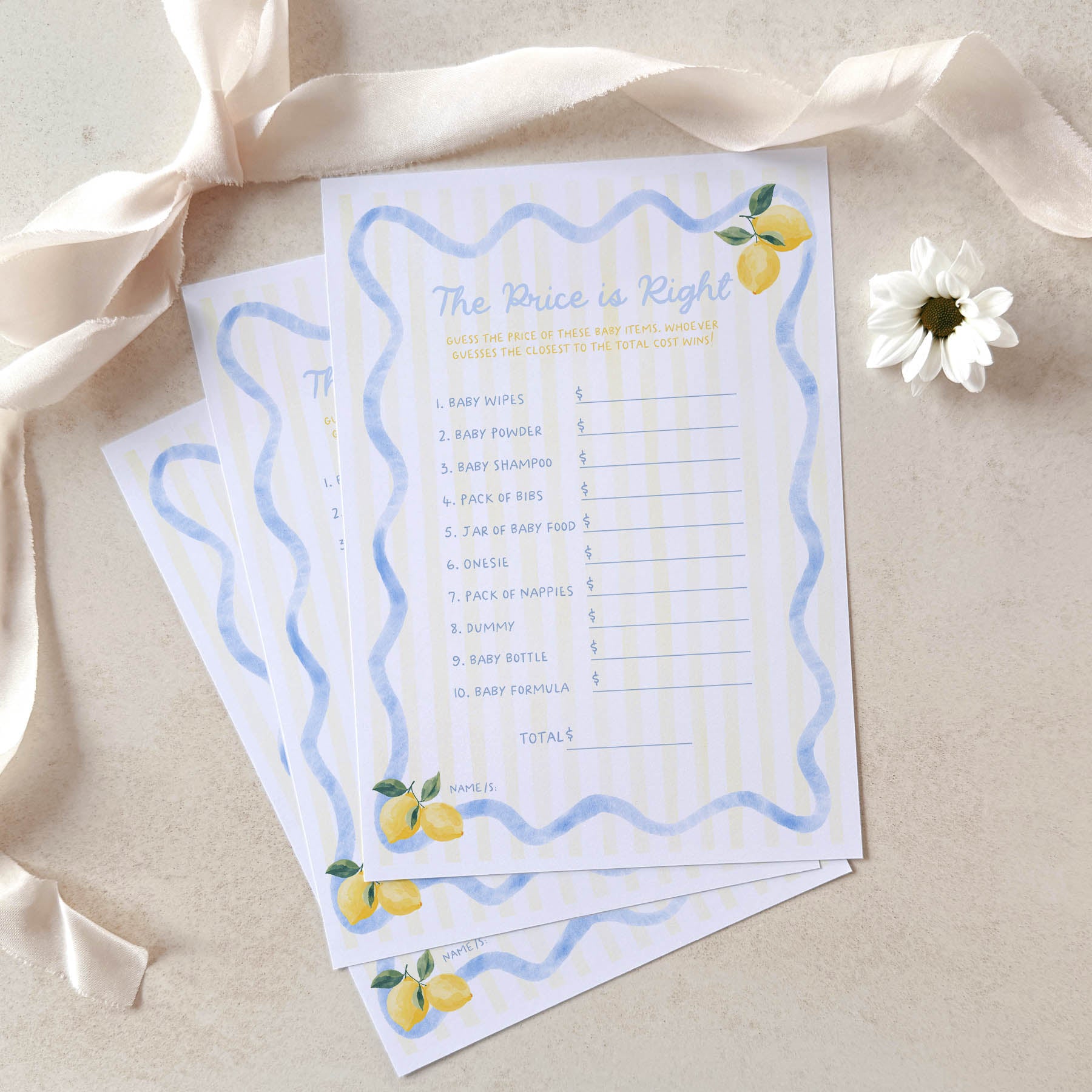 Two baby shower games with lemon designs on a beige background with ribbons and flowers.