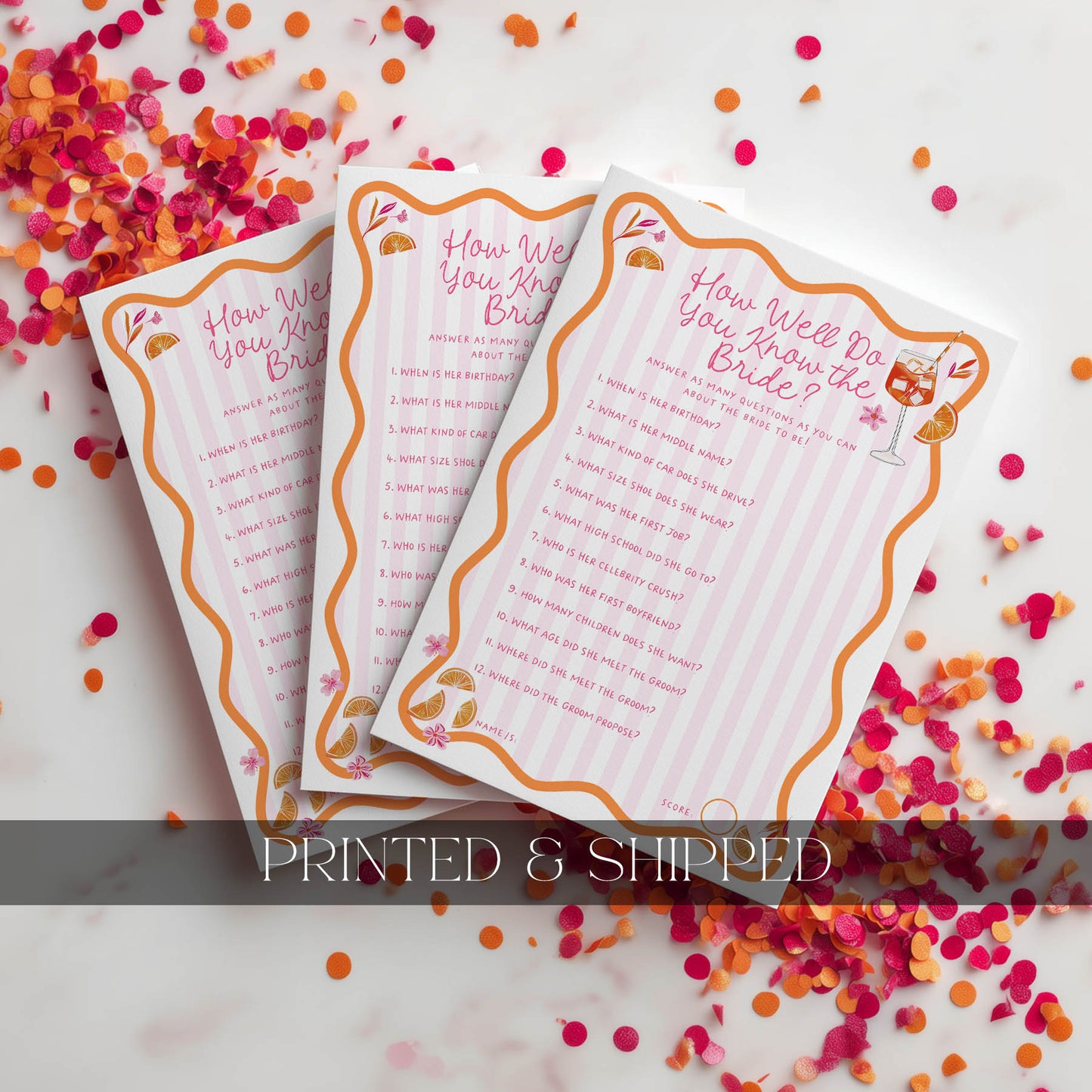 Two printed cards with decorative borders on a confetti-covered surface.