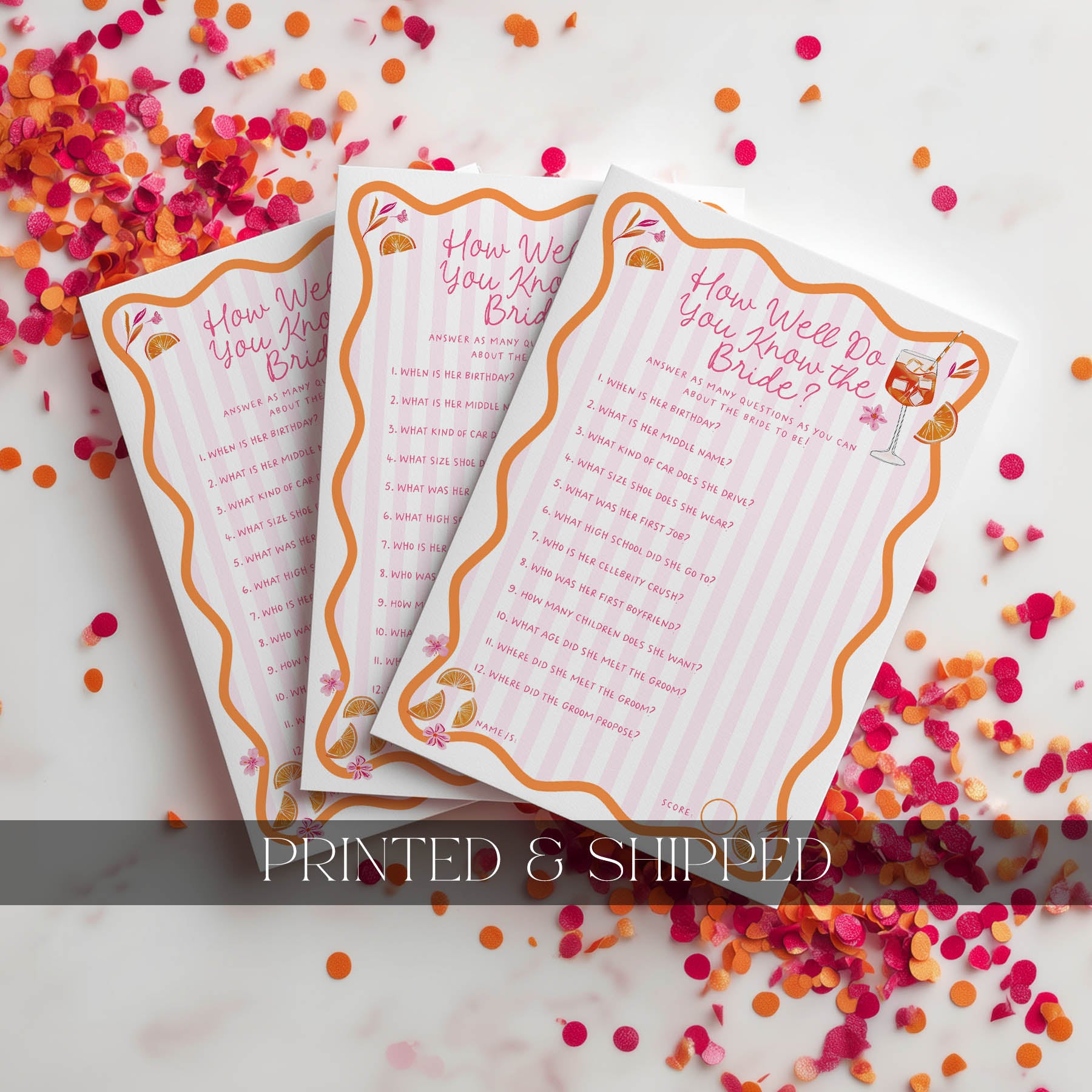 Two printed cards with decorative borders on a confetti-covered surface.