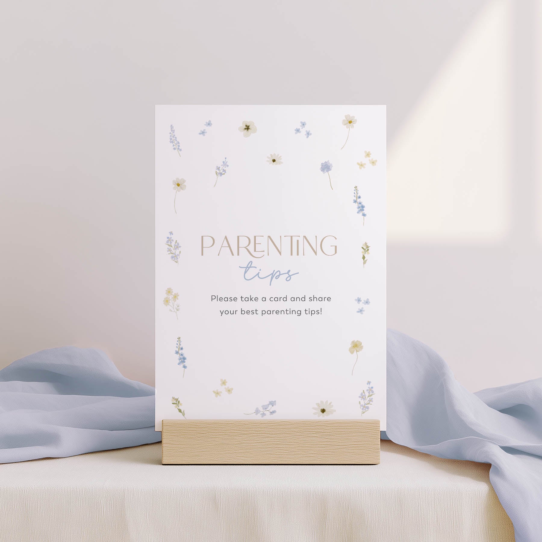 Parenting tips card on a stand with floral design and light blue fabric background