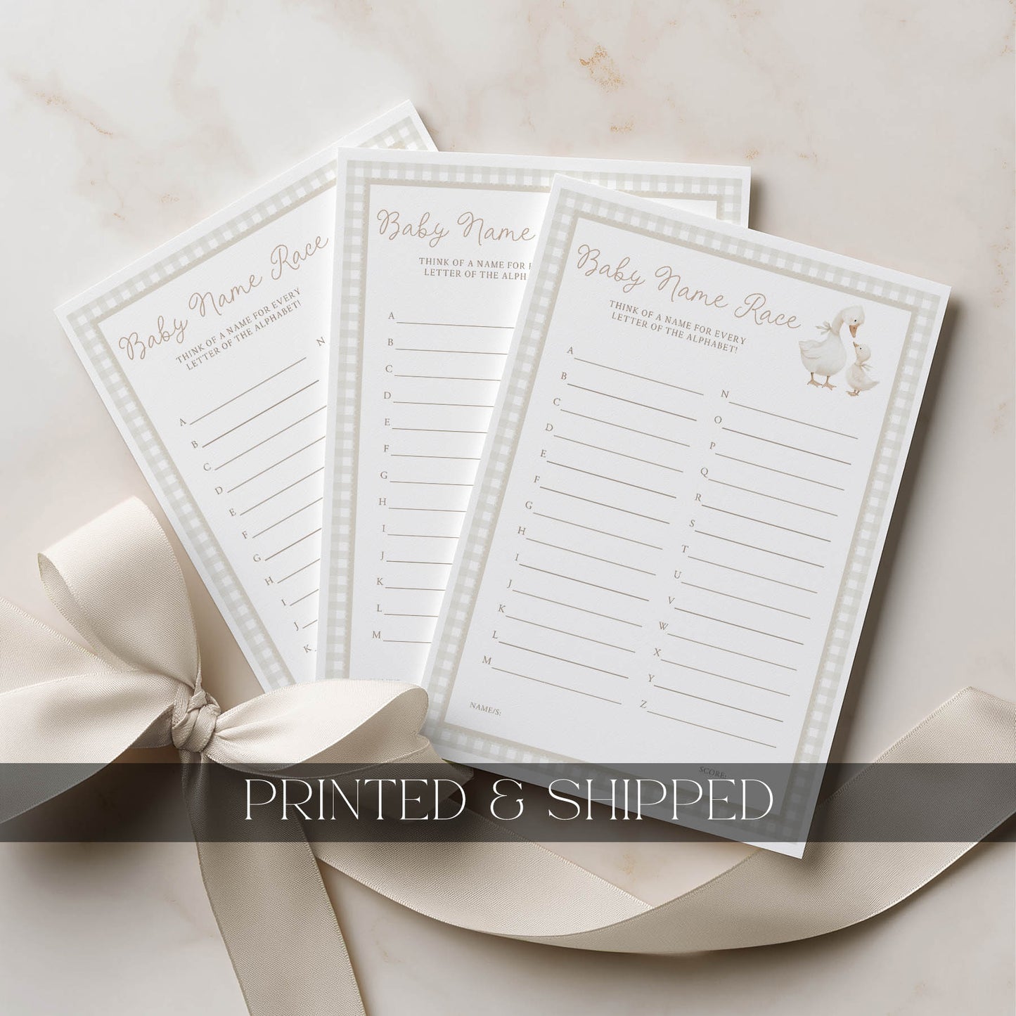 Three printed cards with text on a beige surface with a bow.