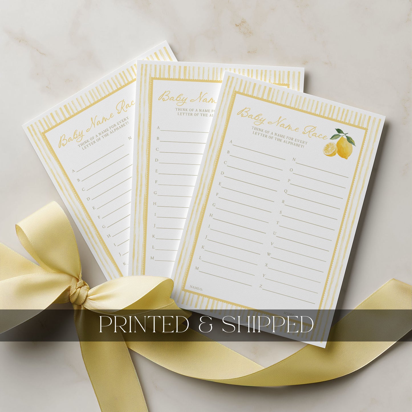 Three baby shower notepads with a yellow ribbon on a light background
