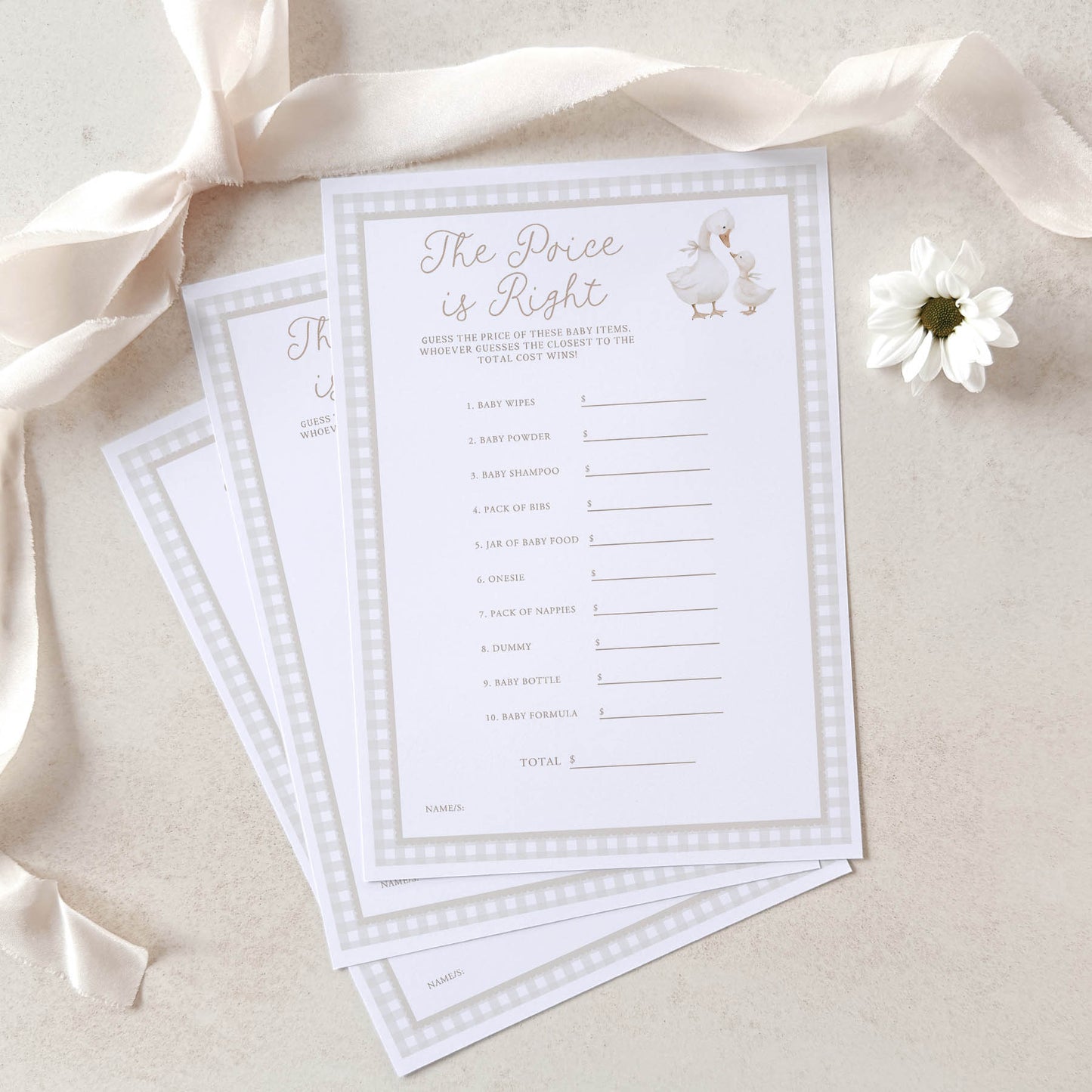 Baby shower game cards with a duck design on a beige background with ribbons and a flower.