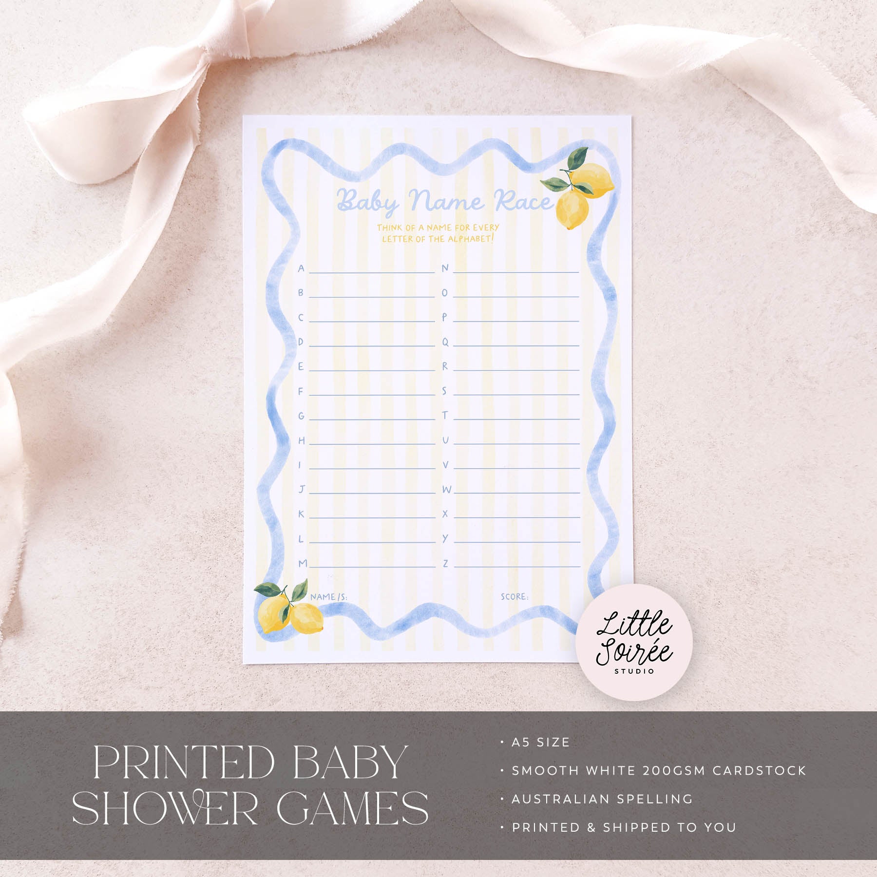 Baby shower game card with lemon design on a light pink fabric background