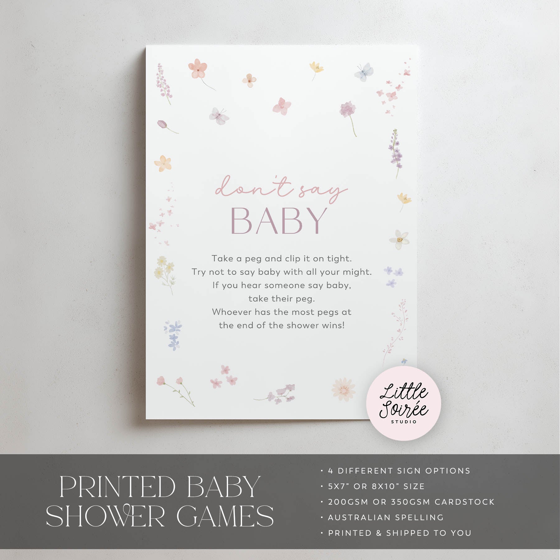 Baby shower game sign with floral design and text on a gray background