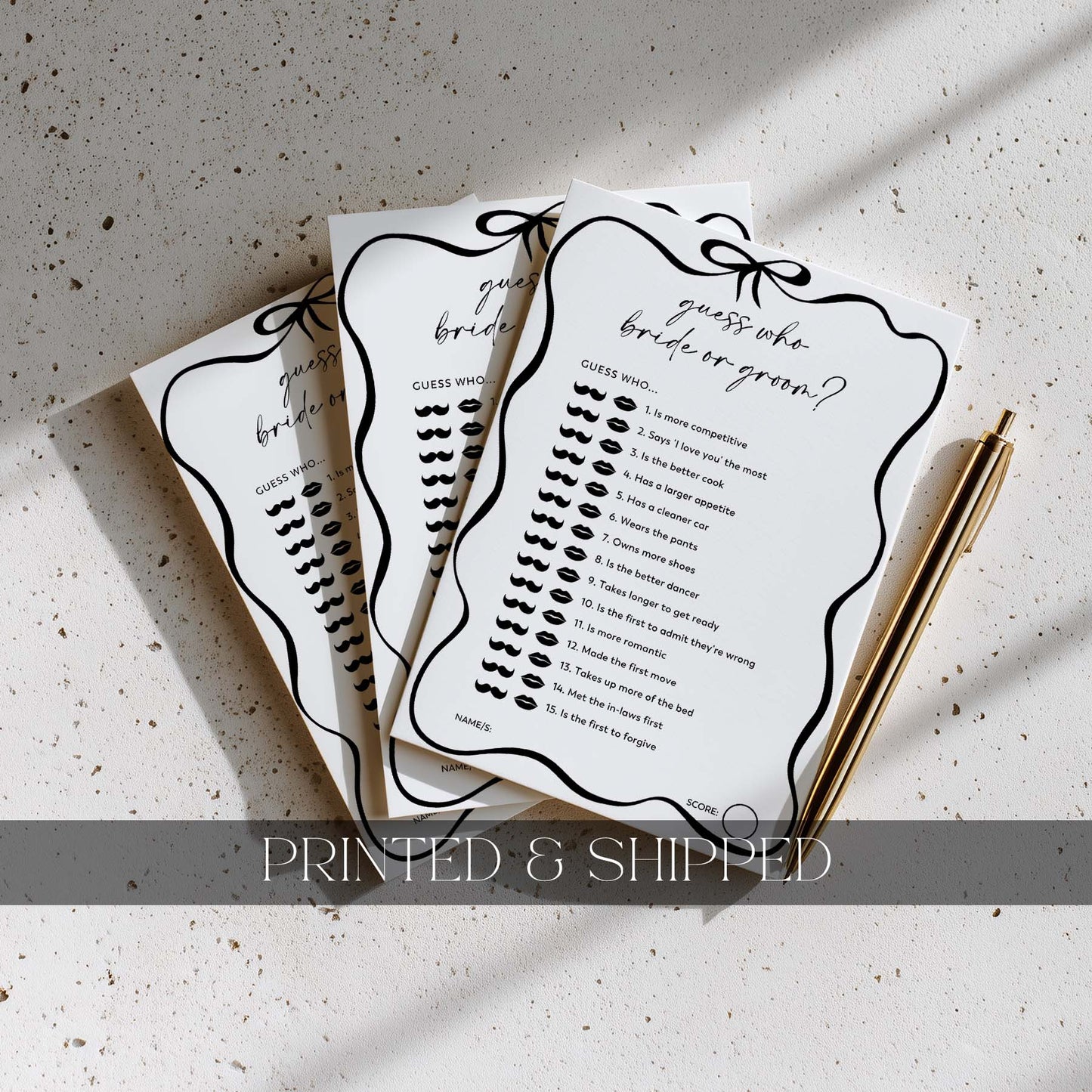 Three printed bridal shower games on a textured surface with a pen.