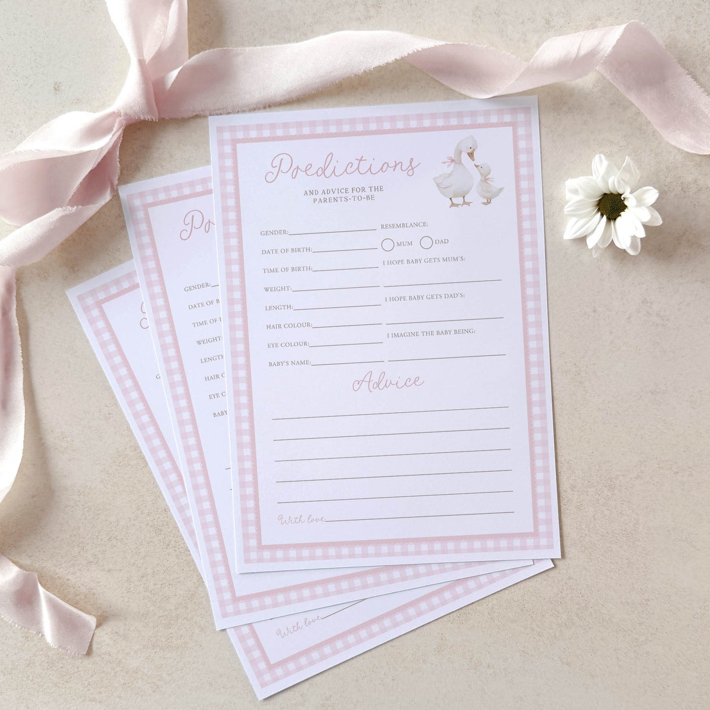 Baby shower prediction and advice cards with a pink ribbon and flower on a beige background