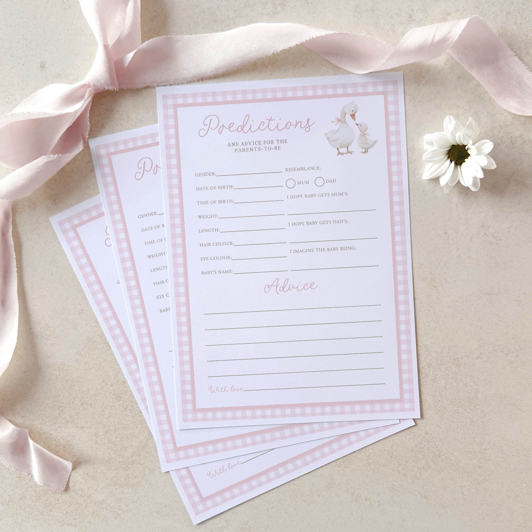 Baby shower prediction and advice cards with a pink ribbon and flower on a beige background